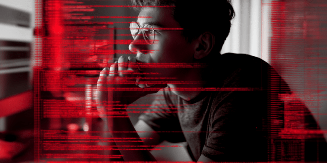 photo du hacker du site Frontière devant son ordinateur avec des lignes de code rouges qui défilent sur l’écran