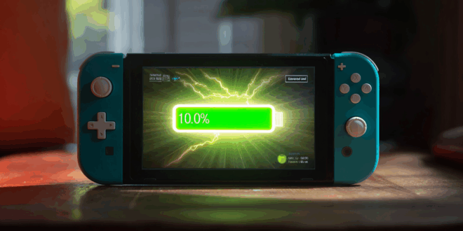 Une Nintendo Switch 2 posée sur une table, affichant un écran lumineux, avec une barre de batterie verte pleine à 100%, entourée d’une aura ou d’un éclair lumineux