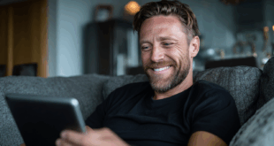 un homme très content avec son iPad à la main