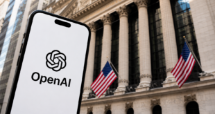 Logo OpenAI affiché sur un smartphone devant un bâtiment financier américain.